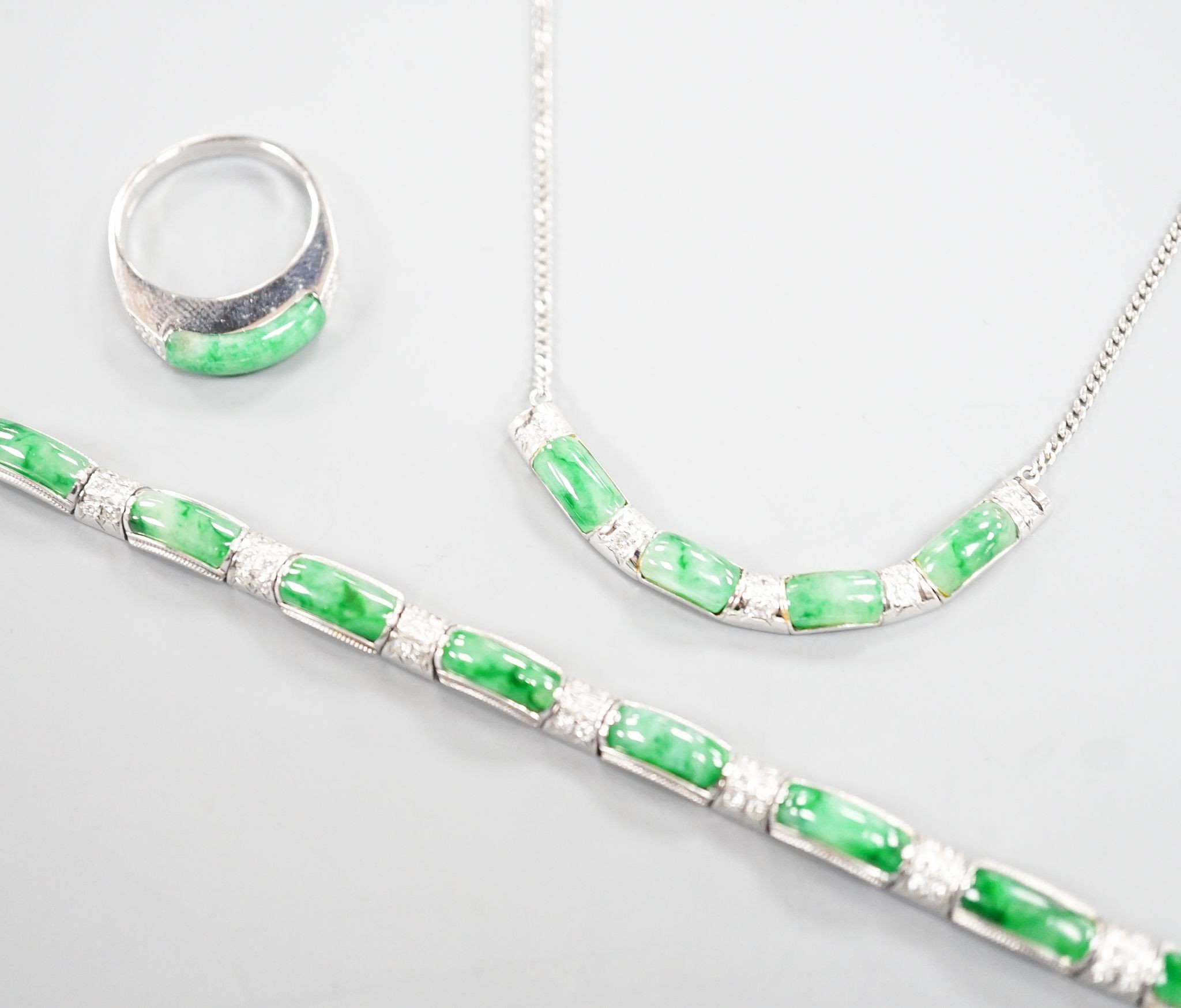 A modern white metal (stamped 850), jade and diamond cluster set bracelet, approx. 15.5cm, with a matching ring, size O and necklace, 38cm